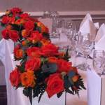 Orange Mirrored Vases Along Top Table
