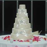 Cake Table Dressed With Rose Petals.